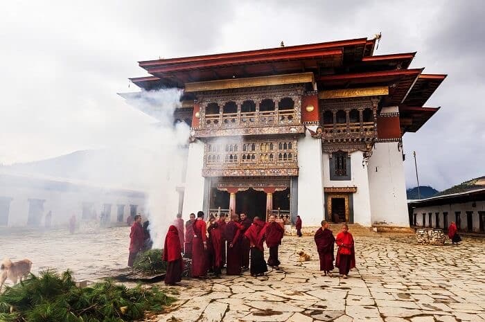 Bhutanese monastery set against forested mountains